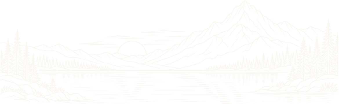 An alpine lake below a mountain range at sunrise