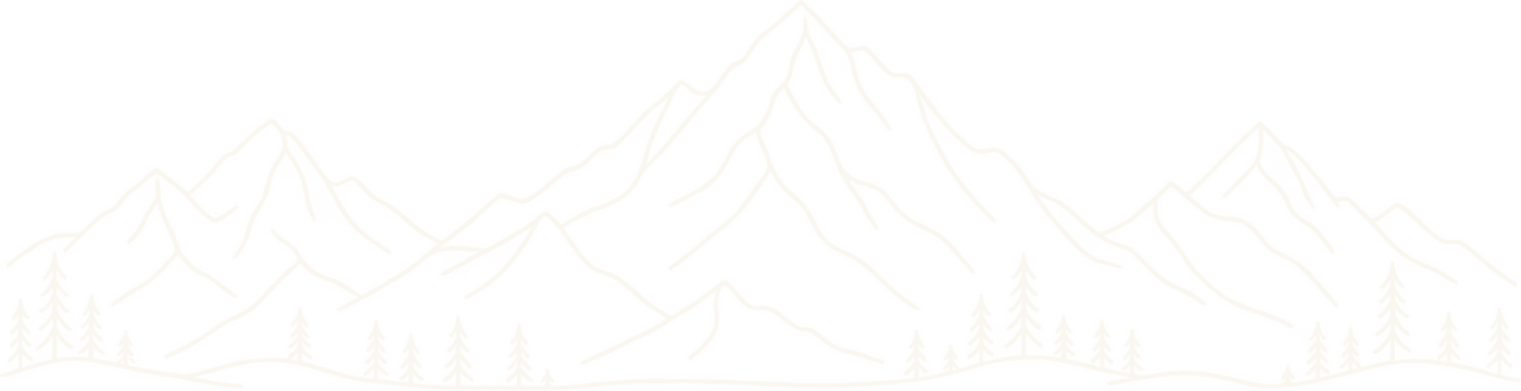 A mountain range lined with pine trees